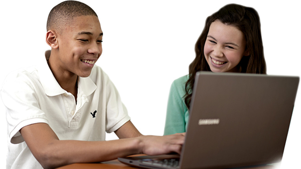 two students smiling, and looking at a laptop