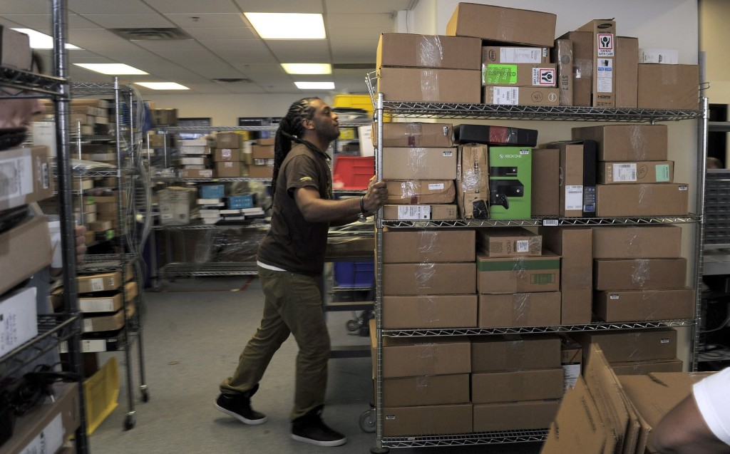 Lanham, MD -- 12/09/2014 -- Paul Alexander moves boxes of equipment into the quality control area for testing and inspection at Optoro's warehouse Tuesday, Dec 9, 2014. [ / _KF23984.JPG] (Karl Merton Ferron / Baltimore Sun)